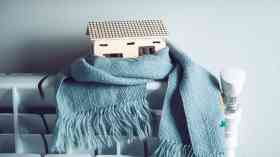 Model house on radiator with a scarf.