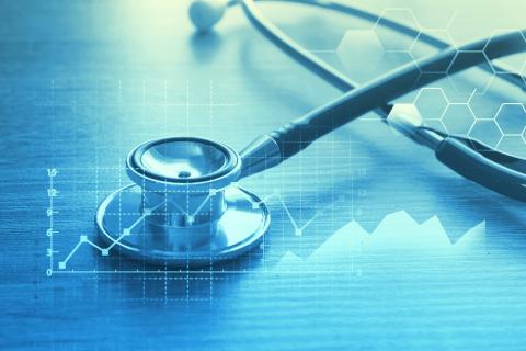 A stephoscope layered over graphics of a line graph with a blue filter. 