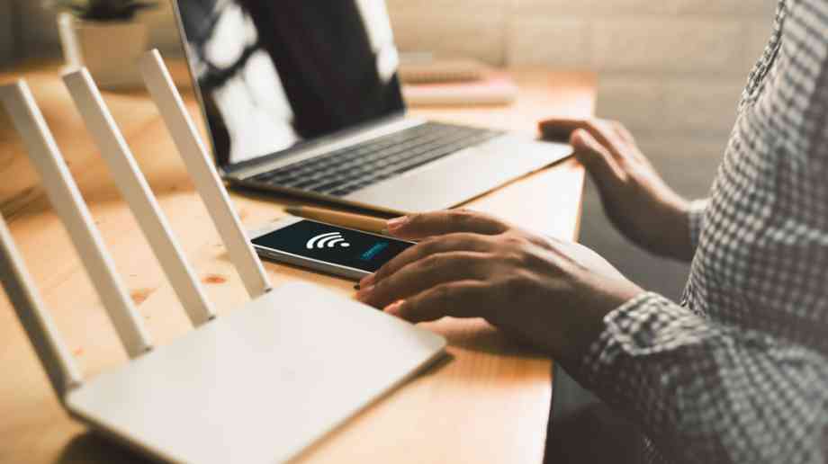 Person at laptop connecting to broadband,.