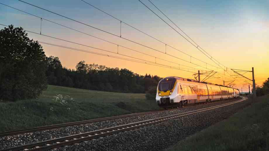 Hi-speed train travelling at sunset.