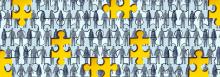 A jigsaw set with some pieces missing. The jigsaw is of lots of people in black and white holding hands. The blank spaces are coloured yellow.