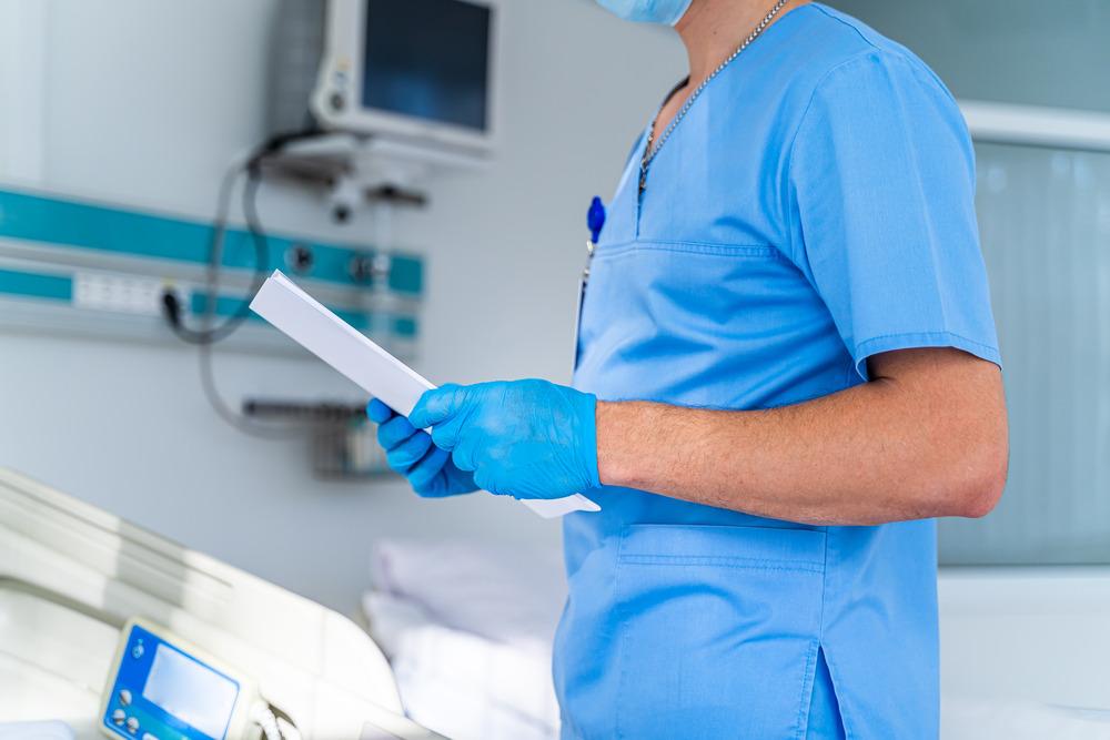 Nurse examining medical records.